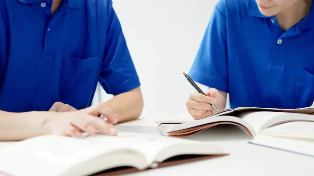 Dental assisting school students reviewing training notes.