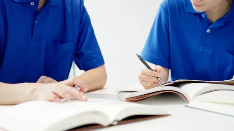 Dental assisting school students reviewing training notes.