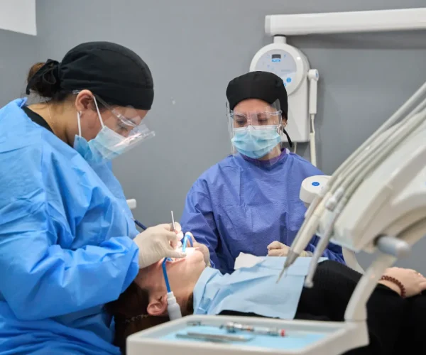 Student learning in a dental assisting program with dentist supervision.