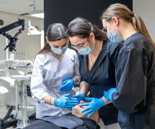 Hygiene assistant aspirants practicing procedures in a training lab.